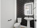 Modern powder room with hexagon tile and pedestal sink at 8425 S 10Th Ln # 1, Phoenix, AZ 85041