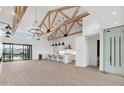 Open living room and kitchen with high ceilings and wood beams at 8425 S 10Th Ln # 1, Phoenix, AZ 85041