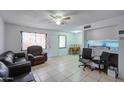 Living room with leather sofas, and a view into the kitchen and dining area at 6842 W Devonshire Ave, Phoenix, AZ 85033