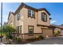 Two-story house with beige stucco, brown accents, and a two-car garage at 16256 W La Ventilla Way, Goodyear, AZ 85338