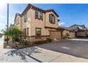 Two-story house with beige stucco, brown accents, and a two-car garage at 16256 W La Ventilla Way, Goodyear, AZ 85338