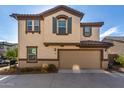 Two-story house with beige stucco, brown accents, and a two-car garage at 16256 W La Ventilla Way, Goodyear, AZ 85338