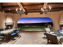 Outdoor patio with fireplace and stunning sunset views at 10719 E Rimrock Dr, Scottsdale, AZ 85255