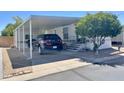Mobile home with carport and landscaping at 7750 E Broadway Rd # 10, Mesa, AZ 85208