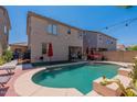 Inviting backyard oasis with sparkling pool and patio at 14760 W Riviera Dr, Surprise, AZ 85379