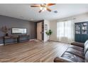 Spacious living room with hardwood floors and a leather couch at 14760 W Riviera Dr, Surprise, AZ 85379