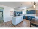 Modern kitchen with blue cabinetry, island, and quartz countertops at 14760 W Riviera Dr, Surprise, AZ 85379