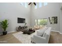 Spacious living room with high ceilings, large windows, and a neutral color palette at 1860 W Buckhorn Trl, Phoenix, AZ 85085