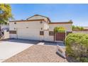 Front view of a charming two-story home with a two-car garage at 1023 E Escuda Dr, Phoenix, AZ 85024