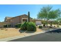 One story home with two car garage and manicured desert landscaping at 7855 E Kramer St, Mesa, AZ 85207