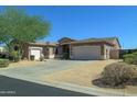 Single story home with two car garage and desert landscaping at 7855 E Kramer St, Mesa, AZ 85207