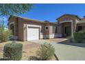 Single story home with a two car garage and nicely landscaped front yard at 7855 E Kramer St, Mesa, AZ 85207