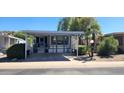 Mobile home exterior with carport, landscaping, and palm trees at 2233 E Behrend Dr # 41, Phoenix, AZ 85024