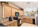 Kitchen with oak cabinets and granite countertops at 19667 N Marquez Cir, Maricopa, AZ 85138