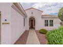 Front entryway with arched door and walkway at 13441 W El Sueno Ct, Sun City West, AZ 85375