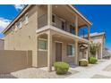 Two-story tan house with a balcony and landscaping at 842 E Agua Fria Ln, Avondale, AZ 85323