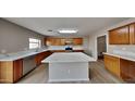 Modern kitchen with light wood cabinets and a large kitchen island at 45612 W Tucker Rd, Maricopa, AZ 85139