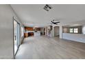 Open living room with light wood laminate floors and kitchen island at 45612 W Tucker Rd, Maricopa, AZ 85139