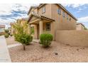 Tan two-story house with a small front yard and landscaping at 915 E Agua Fria Ln, Avondale, AZ 85323