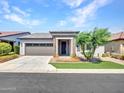 Charming curb appeal with grey garage door and artificial turf at 20358 W Calle Encorvada --, Buckeye, AZ 85396