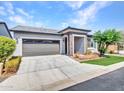 Single story home with grey garage door and landscaped lawn at 20358 W Calle Encorvada --, Buckeye, AZ 85396