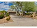 One-story home with driveway and desert landscaping at 6717 E Brilliant Sky Dr, Scottsdale, AZ 85266