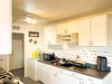 Bright kitchen with white cabinets and tiled backsplash at 6767 N 7Th St # 217, Phoenix, AZ 85014