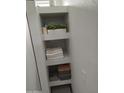 Bathroom shelving with folded towels and storage containers at 10232 W Campbell Ave, Phoenix, AZ 85037