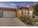 Modern home exterior with a two-car garage and stone accents at 17632 E Chevelon Canyon Cir, Rio Verde, AZ 85263