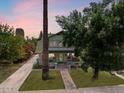 Two-story home with brick facade, palm trees, and landscaped yard at 73 W Lewis Ave, Phoenix, AZ 85003