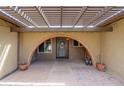 Brick entryway with arched doorway and covered pergola at 5119 W Onyx Ave, Glendale, AZ 85302
