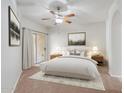 Spacious bedroom with ceiling fan and access to balcony at 14575 W Mountain View Blvd # 221, Surprise, AZ 85374