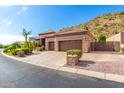 Two-story house with a three-car garage and desert landscaping at 9845 E Inglewood St, Mesa, AZ 85207