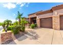 Home with a three-car garage and nicely landscaped front yard at 9845 E Inglewood St, Mesa, AZ 85207