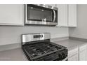 Stainless steel gas range with microwave above at 1521 W Saddle Run, Apache Junction, AZ 85120
