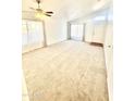 Bright and spacious living room with neutral carpeting and lots of natural light at 1639 E Redfield Rd, Gilbert, AZ 85234