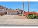 Charming home exterior with a two-car garage and lush landscaping at 1639 E Redfield Rd, Gilbert, AZ 85234
