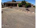 Landscaped front yard with a large one-story home at 376 N Iron Horse Dr, Coolidge, AZ 85128