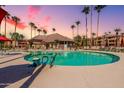 Community pool with surrounding patio furniture at 14950 W Mountain View Blvd # 1203, Surprise, AZ 85374