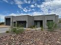 Modern home exterior with two-car garage and desert landscaping at 10569 N 131St St, Scottsdale, AZ 85259