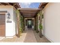 Covered entryway with a pergola and brick walkway at 7659 E Knoll St, Mesa, AZ 85207