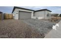 Paved driveway leading to a two-car garage with a side gate at 22730 E Roundup Way, Queen Creek, AZ 85142