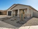 One-story home with a two-car garage and stone accents at 2585 E San Miguel Dr, Casa Grande, AZ 85194