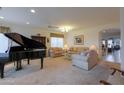 Spacious living room featuring comfortable sofas and a grand piano at 29922 N Little Leaf Dr, San Tan Valley, AZ 85143