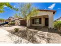 Single-story home with brown garage door and landscaping at 19314 S 208Th Pl, Queen Creek, AZ 85142