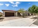 Single-story home with brown garage door and landscaping at 19314 S 208Th Pl, Queen Creek, AZ 85142