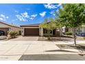 Single-story home with brown garage door and landscaping at 19314 S 208Th Pl, Queen Creek, AZ 85142