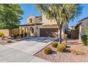 Two-story house with a two-car garage and landscaping at 11040 E Tumbleweed Ave, Mesa, AZ 85212
