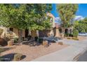 Two-story house with a two-car garage and landscaping at 11040 E Tumbleweed Ave, Mesa, AZ 85212
