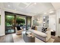 Living area with access to a private patio, featuring a comfy sofa at 7175 E Camelback Rd # 107, Scottsdale, AZ 85251
